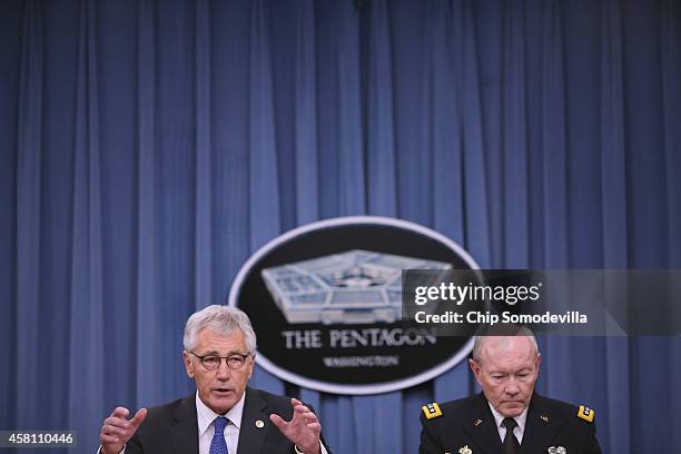 Defense Secretary Chuck Hagel and Chairman of the Joint Chiefs of Staff Gen. Martin Dempsey hold a news conference at the Pentagon October 30, 2014...