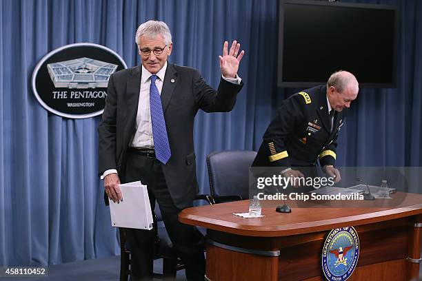 Defense Secretary Chuck Hagel waves goodbye as he and Chairman of the Joint Chiefs of Staff Gen. Martin Dempsey complete a news conference at the...