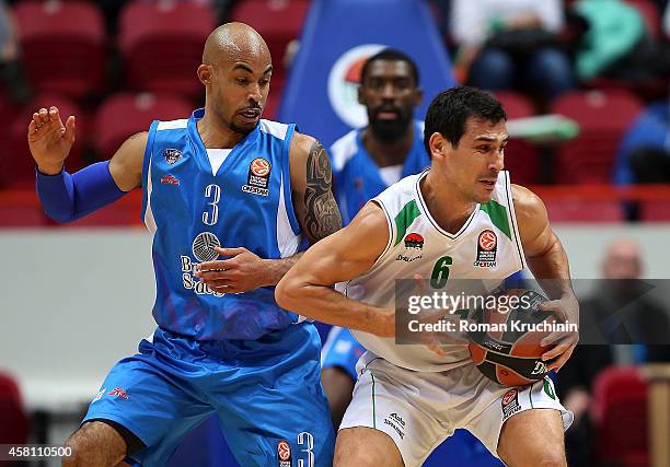 Nikos Zisis, #6 of Unics Kazan competes with David Logan, #3 of Dinamo Banco di Sardegna Sassari during the 2014-2015 Turkish Airlines Euroleague...