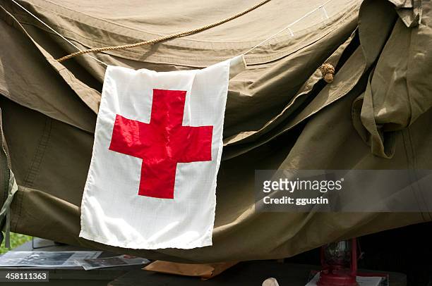 first aid/medic flag on military tent - red cross stock pictures, royalty-free photos & images