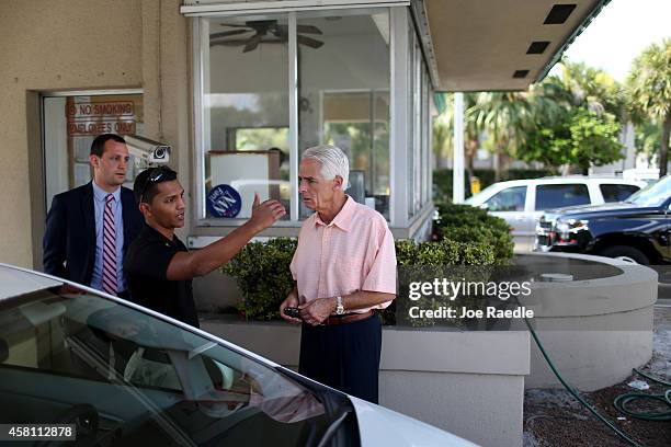 Former Florida Governor and now Democratic gubernatorial candidate Charlie Crist speaks to a security guard as he asks him to allow the media in to...