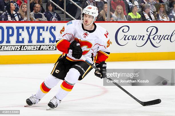 Paul Byron of the Calgary Flames keeps an eye on the play during first period action against the Winnipeg Jets on October 19, 2014 at the MTS Centre...