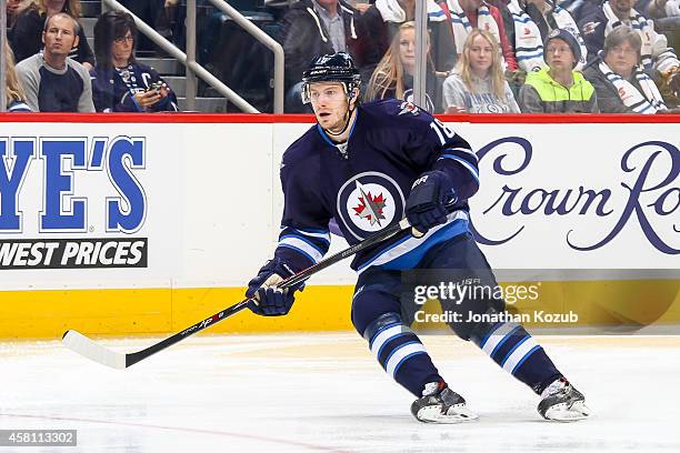 Bryan Little of the Winnipeg Jets keeps an eye on the play during first period action against the Calgary Flames on October 19, 2014 at the MTS...