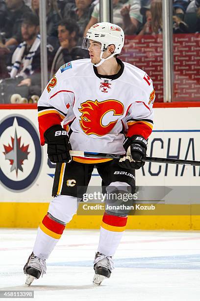 Paul Byron of the Calgary Flames keeps an eye on the play during third period action against the Winnipeg Jets on October 19, 2014 at the MTS Centre...