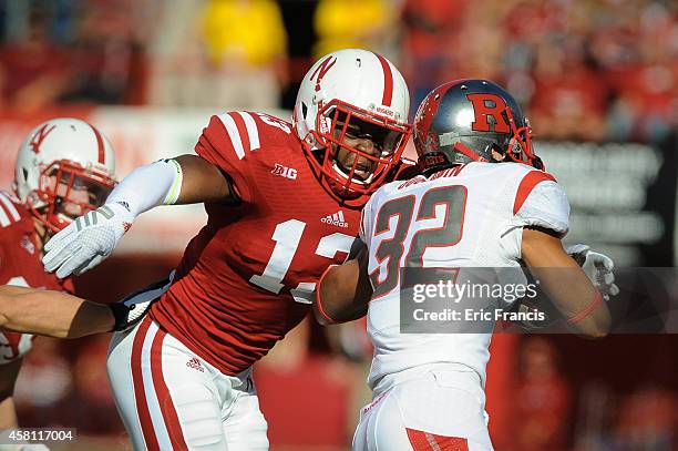 Linebacker Zaire Anderson of the Nebraska Cornhuskers looks to tackle running back Justin Goodwin of the Rutgers Scarlet Knights in action during the...