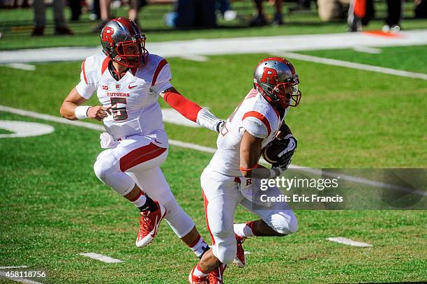 Quarterback Chris Laviano of the Rutgers Scarlet Knights hands off to running back Justin Goodwin of the Rutgers Scarlet Knights in action during the...