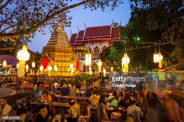 wat phra singh on market night in chiang mai - chiang mai province stock pictures, royalty-free photos & images