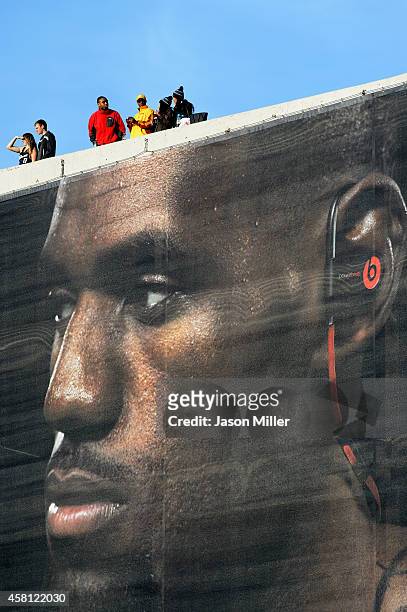 Fans look on from above a LeBron James banner outside Quicken Loans Arena before a game between the Cleveland Cavaliers and the New York Knicks on...