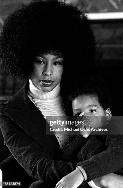 Marguerite Simpson, wife of O. J. Simpson, poses for a portrait at home while holding her son Jason on January 8, 1973 in Los Angeles, California.