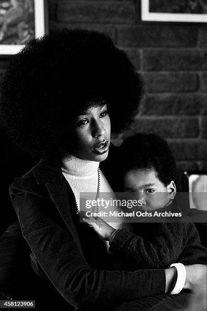 Marguerite Simpson, wife of O. J. Simpson, poses for a portrait at home while holding her son Jason on January 8, 1973 in Los Angeles, California.
