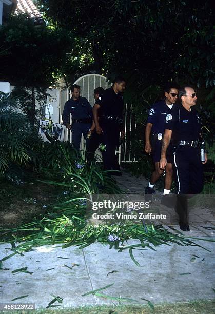 Police investigators look over the crime scene at the Brentwood condo after the bodies of Nicole Brown Simpson and Ron Goldman were found on June 13,...