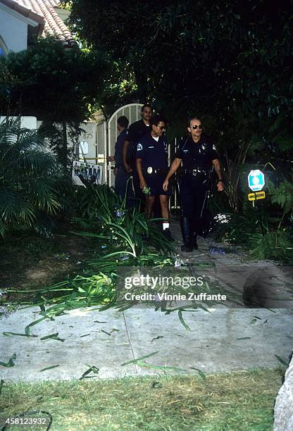 Police investigators look over the crime scene at the Brentwood condo after the bodies of Nicole Brown Simpson and Ron Goldman were found on June 13,...