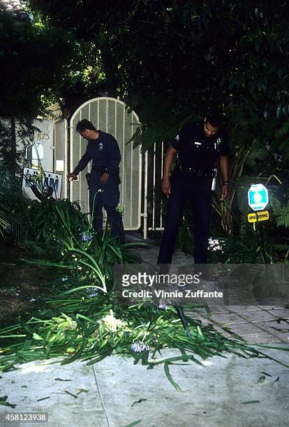 Police investigators look over the crime scene at the Brentwood condo after the bodies of Nicole Brown Simpson and Ron Goldman were found on June 13,...