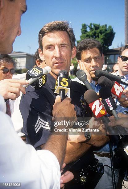 An unidentified police officer speaks to the media at the Brentwood condo where Nicole Brown Simpson and Ron Goldman were stabbed to death a day...