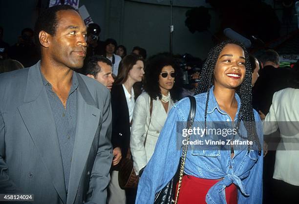 Actor and former NFL player O.J. Simpson and daughter Arnelle arrive for the "Cliffhanger" premiere on May 26, 1993 at the Mann's Chinese Theatre in...