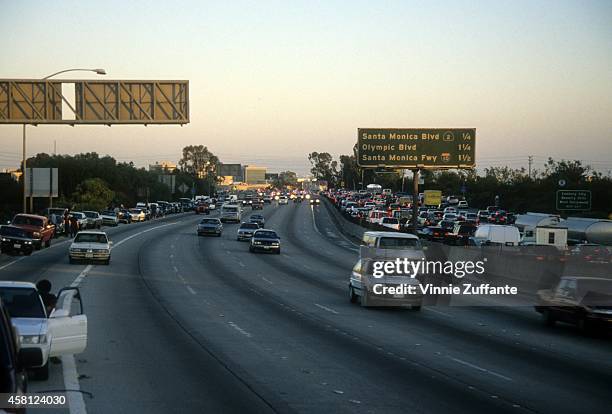 Police cars pursue the Ford Bronco driven by Al Cowlings, carrying fugitive murder suspect O.J. Simpson, on a 90-minute slow-speed car chase June 17,...