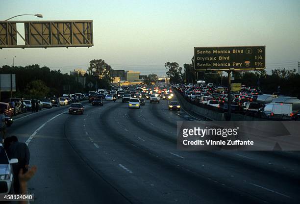 Police cars pursue the Ford Bronco driven by Al Cowlings, carrying fugitive murder suspect O.J. Simpson, on a 90-minute slow-speed car chase June 17,...