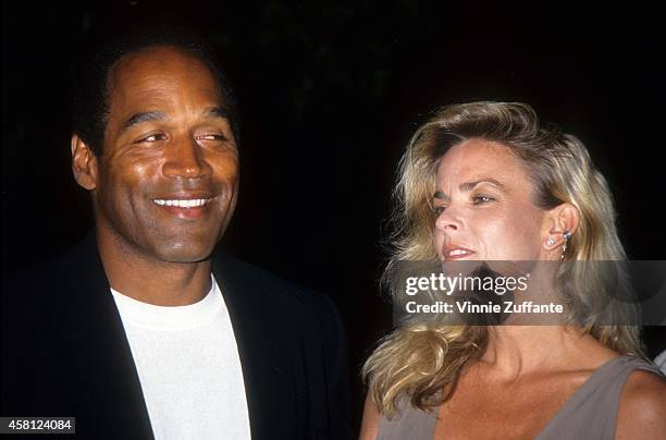 Simpson and Nicole Brown Simpson pose at the premiere of the "Naked Gun 33 1/3: The Final Isult" in which O.J. Starred on March 16, 1994 in Los...