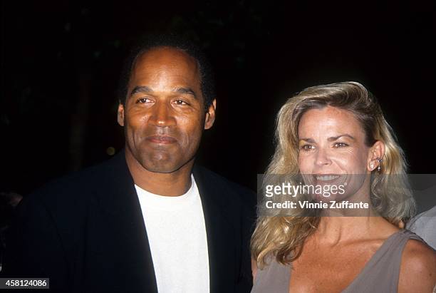 Simpson and Nicole Brown Simpson pose at the premiere of the "Naked Gun 33 1/3: The Final Isult" in which O.J. Starred on March 16, 1994 in Los...