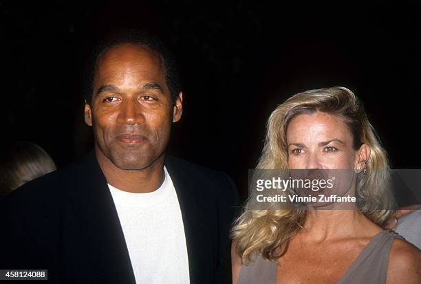Simpson and Nicole Brown Simpson pose at the premiere of the "Naked Gun 33 1/3: The Final Isult" in which O.J. Starred on March 16, 1994 in Los...