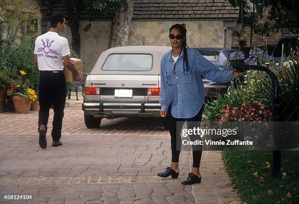 Arnelle Simpson, daughter of O.J. Simpson, buzzes a delivery in at the Rockingham Estate in June, 1994 in Brentwood, California.