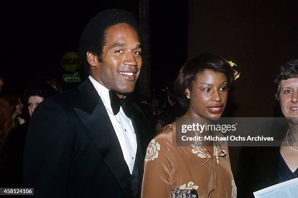 Player and actor O.J. Simpson and wife Marguerite Simpson pose for a portrait at a movie premiere in 1977 in Los Angeles, California.
