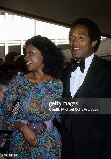 Player and actor O.J. Simpson and wife Marguerite Simpson pose for a portrait at a movie premiere in April, 1977 in Los Angeles, California.