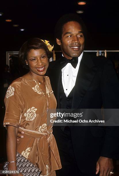 Player and actor O.J. Simpson and wife Marguerite Simpson pose for a portrait at a movie premiere in 1977 in Los Angeles, California.
