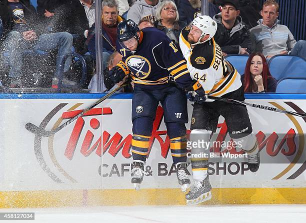 Torrey Mitchell of the Buffalo Sabres and Dennis Seidenberg of the Boston Bruins collide along the boards on October 30, 2014 at the First Niagara...