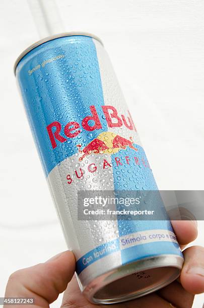 hand holding red bull light cans - suikervrij stockfoto's en -beelden