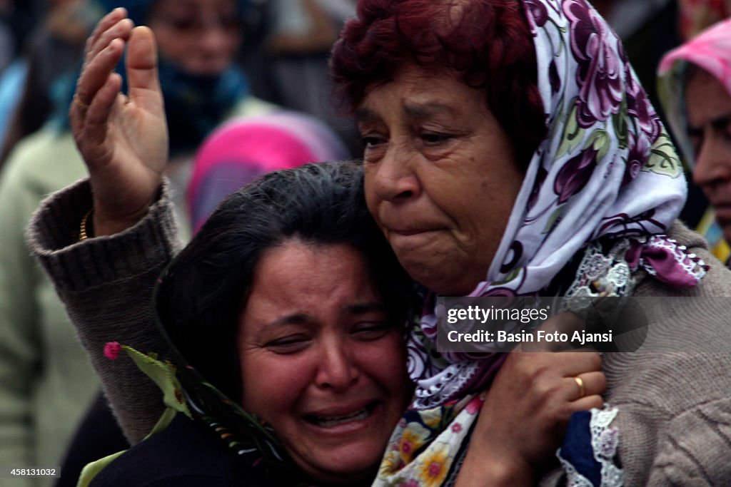 The relatives of the workers are waiting in front of the...