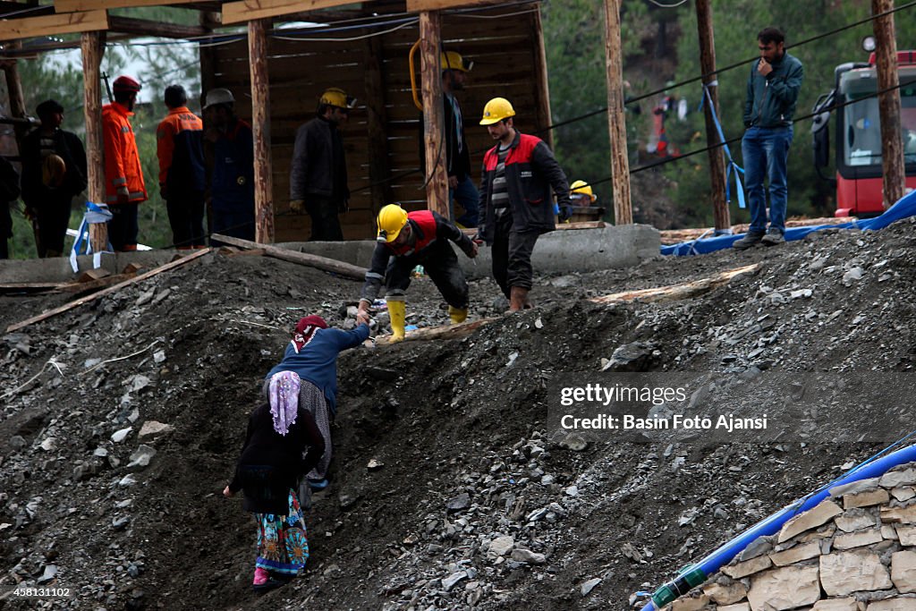 The relatives of the workers are waiting in front of the...