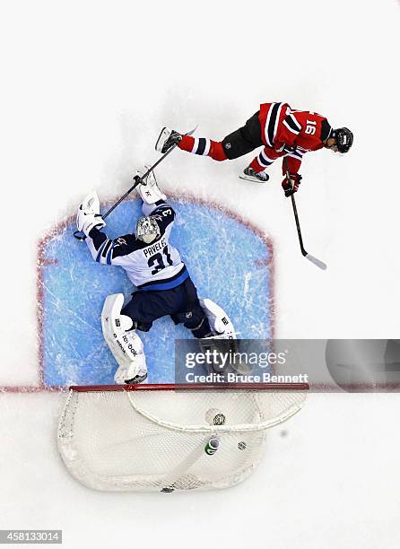 Jacob Josefson of the New Jersey Devils scores the game winning goal during the shootout against Ondrej Pavelec of the Winnipeg Jets at the...