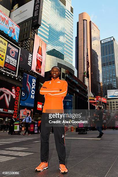 Geoffrey Mutai poses for a picture at Times Square on October 30, 2014 in New York City.