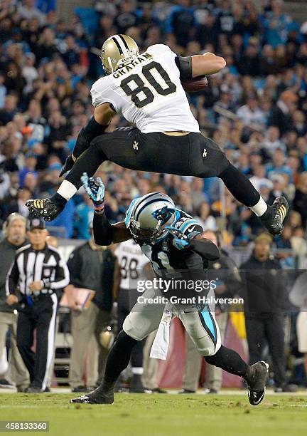 Jimmy Graham of the New Orleans Saints hurdles Roman Harper of the Carolina Panthers during their game at Bank of America Stadium on October 30, 2014...