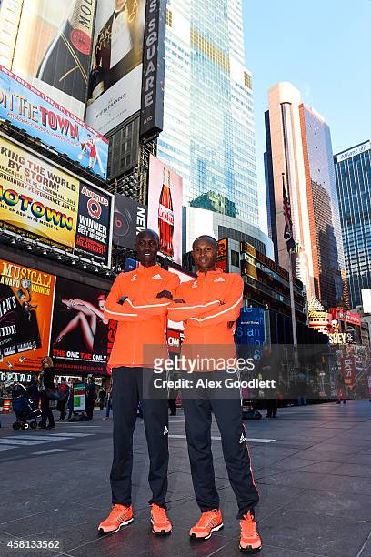Wilson Kipsang and Geoffrey Mutai pose for a picture at Times Square on October 30, 2014 in New York City.