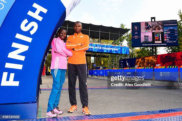 Mary Keitany poses for a picture with Geoffrey Mutai at the TCS New York City Marathon finish line on October 30, 2014 in New York City.