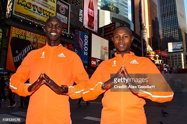Wilson Kipsang and Geoffrey Mutai pose for a picture at Times Square on October 30, 2014 in New York City.