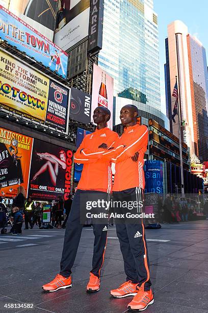 Wilson Kipsang and Geoffrey Mutai pose for a picture at Times Square on October 30, 2014 in New York City.