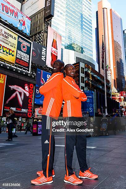 Wilson Kipsang and Geoffrey Mutai pose for a picture at Times Square on October 30, 2014 in New York City.