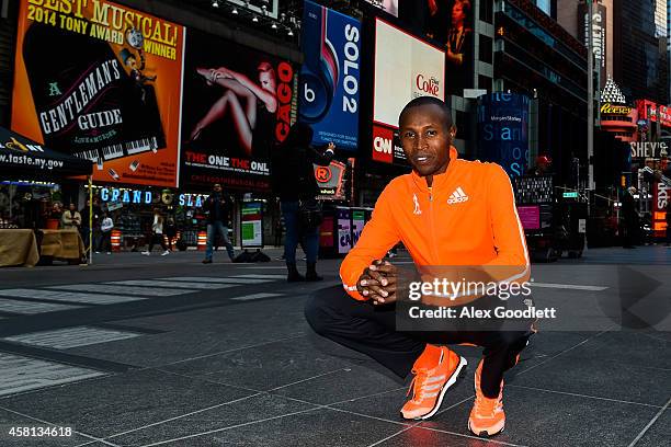 Geoffrey Mutai poses for a picture at Times Square on October 30, 2014 in New York City.