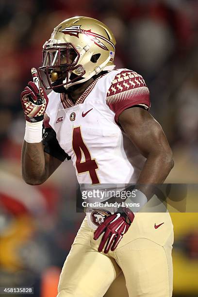 Dalvin Cook of the Florida State Seminoles celebrates after running a 40 yard touchdown in the third quarter against the Louisville Cardinals during...