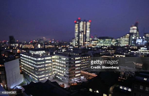 Lights illuminate the windows of an office block as it stands in the area known as London's Tech City, in this image taken with a tilt-shift lens...