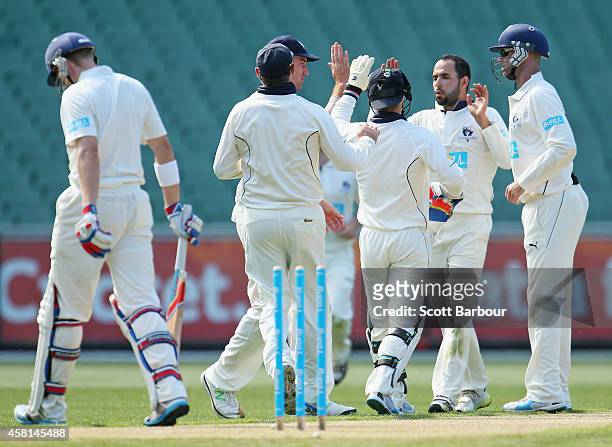 Fawad Ahmed of Victoria is congratulated by his teammates after dismissing Scott Henry of New South Wales during day one of the Sheffield Shield...