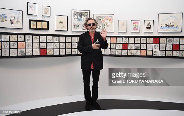 Movie director Tim Burton poses for photographers during a press preview of 'the World of Tim Burton' exhibition in Tokyo on October 31, 2014. The...