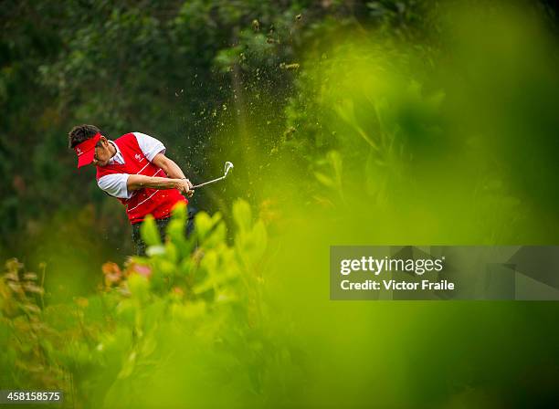 Hiroyuki Fujita of Japan plays a shot at the 6th hole during the Royal Trophy Europe vs Asia Championship at the Dragon Lake Golf Club on December...