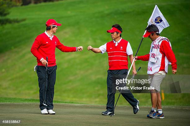 Ryo Ishikawa and Hiroyuki Fujita of Japan celebrate on the 7h green during the Royal Trophy Europe vs Asia Championship at the Dragon Lake Golf Club...