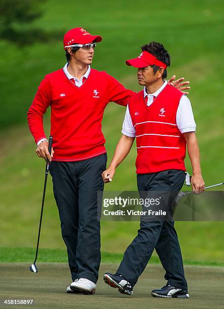 Ryo Ishikawa and Hiroyuki Fujita of Japan celebrate on the 7h green during the Royal Trophy Europe vs Asia Championship at the Dragon Lake Golf Club...