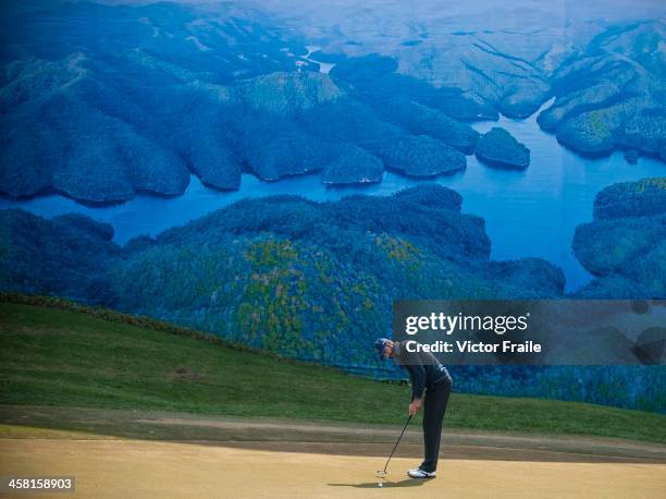 Alvaro Quiros of Spain putts on at the 6th green during the Royal Trophy Europe vs Asia Championship at the Dragon Lake Golf Club on December 20,...