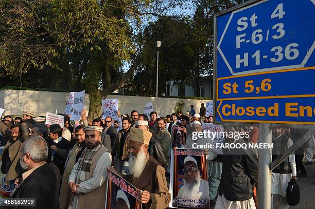 Pakistani civil society and Jamaat-e-Islami party activists protest outside the Bangladeshi embassy in Islamabad on December 20 against the execution...